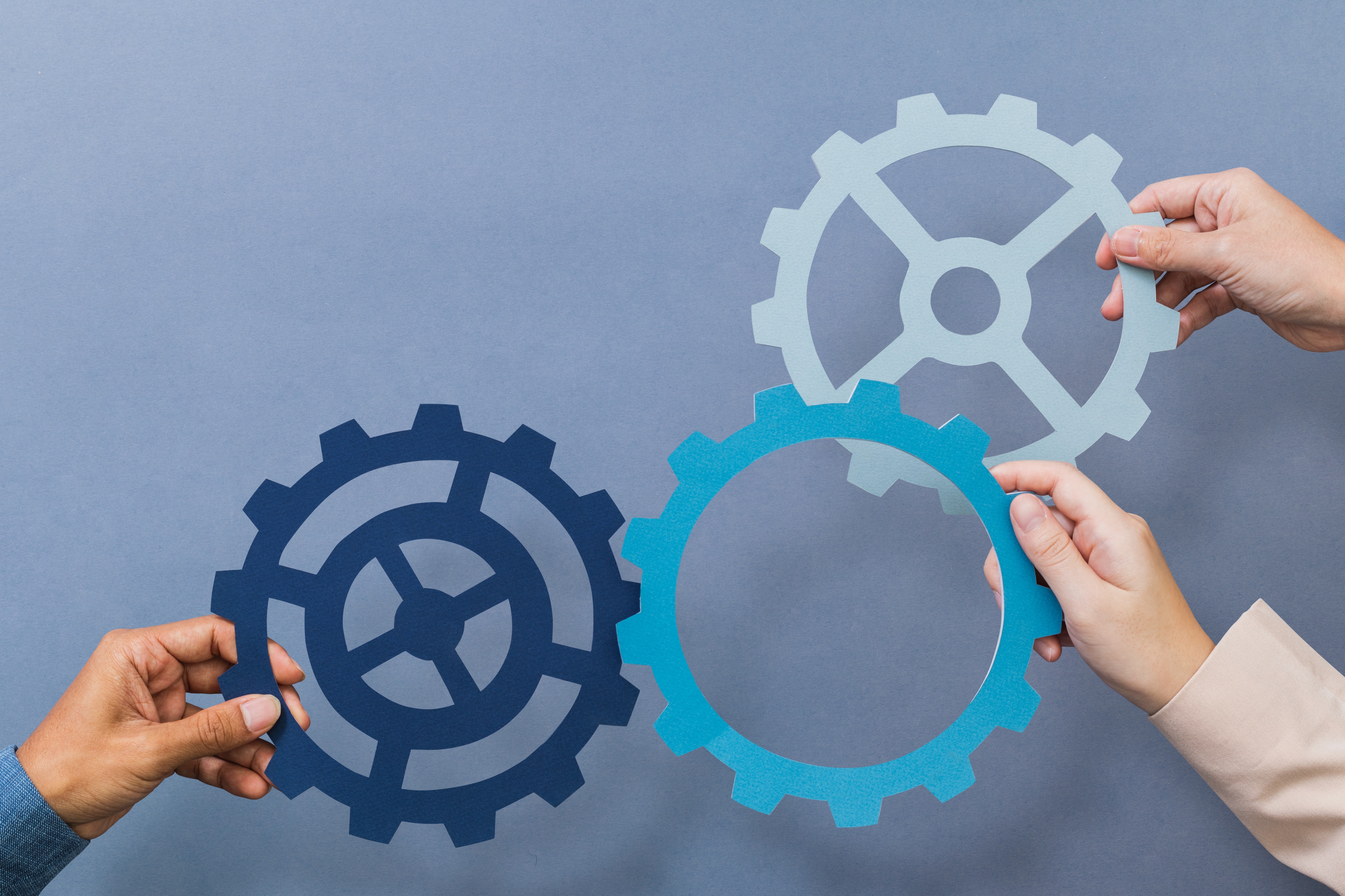 cogwheel-business-productivity-symbol-held-by-hands (1)